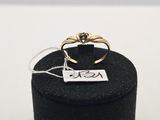 a close up of a ring in a black box on a white surface