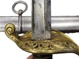 a close up of a sword with a gold handle