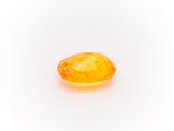 a yellow sapphire stone on a white background