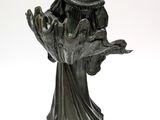 bronze statue of a woman holding a bird on a wooden base