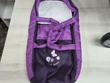 a purple baby stroller with a purple cover on a table