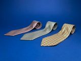 three different colors of ties on a blue background
