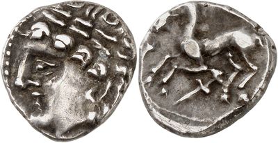 a silver coin with a horse and rider on it