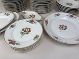 a lot of plates that are sitting on a table