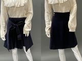 two mannequins dressed in white shirts and black skirts