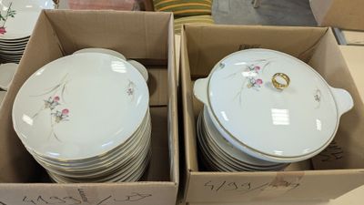many plates and bowls in a box on the table