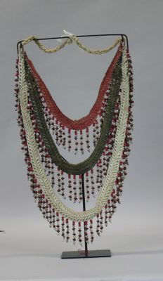 a multi - colored beaded necklace on a metal stand