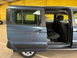 a blue van with its doors open in a parking lot