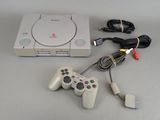a video game console and a game controller on a table