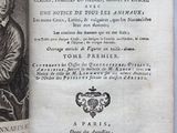 an old book with a picture of a man holding a dog