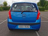 a blue car that is parked in a parking lot