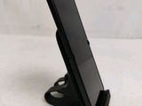 a cell phone that is on a stand on the table