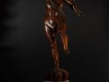 a bronze statue of an angel on a pedestal