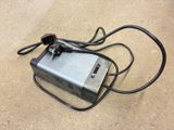 a power cord connected to an electrical device on the ground