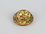 a small bowl of food on a saucer on a table