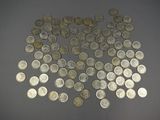 a lot of silver coins on a gray surface