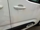 a close up of a car door handle with a sticker on it