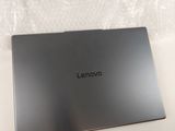 lenovo laptop computer sitting on top of a white box on a table