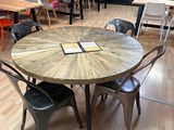tables and chairs in a room with a large mural on the wall