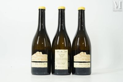 three bottles of wine sitting on top of a table next to each other
