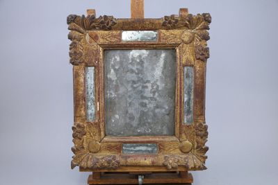 a picture of a mirror on a wooden easel