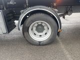 a truck with a flat tire parked on the street