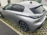 the rear end of a silver car parked in a parking lot