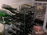 many bottles of wine sitting on a rack in a wine cellar