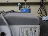 a gray box on a black counter top with wires and wires