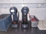 trois machines à café posées sur un plan de travail dans une cuisine