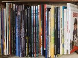 many books in a box on the shelf
