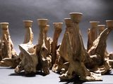 a group of wooden candles that are sitting on a table