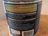 a close up of a can of paint on a wooden table