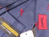 a label on a blue necktie with red and black designs