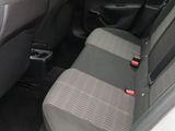 the back seats of a car with a cup holder in the center