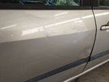 a white car with a blue stripe on the side of it