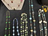 a group of necklaces and bracelets on display on a table