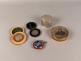 five different types of jewelry sitting on a white surface