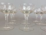 many wine glasses lined up on a table