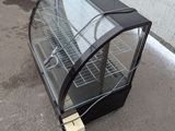 a glass display case sitting on the ground next to a pallet