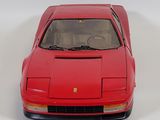 a red model of a sports car on a white surface