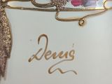 a close up of a vase with flowers on it