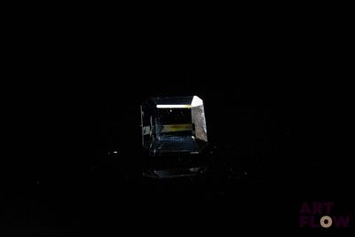 a black room with a chair and a window in it