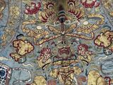 a blue and gold oriental rug on the floor