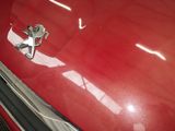 a close up of a car ' s emblem on a red car