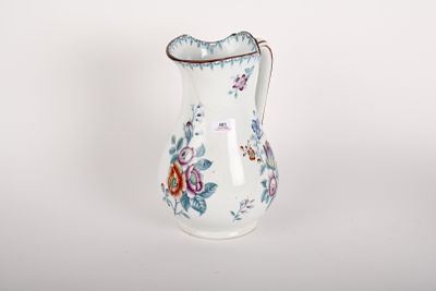 a white vase with a floral design on it
