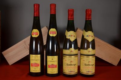 four bottles of wine are lined up on a table
