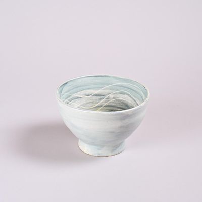 a white bowl with a blue and green design on it
