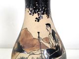 a vase with a picture of a man riding a horse