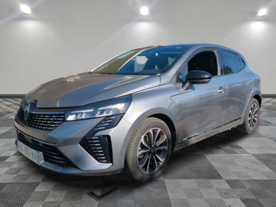 a silver car parked on a checkered floor in a garage